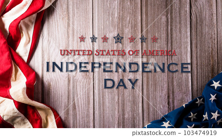 4th of July happy Independence day concept. Vintage American flag and the text on old wooden background. 4th of July happy Independence day concept. Vintage American flag and the text on old wooden background. 103474919