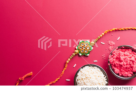 Raksha Bandhan, Indian festival with beautiful Rakhi and Rice Grains. A traditional Indian wrist band which is a symbol of love between Sisters and Brothers 103474937