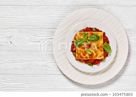 portion of upside down pizza on white plate 103475803