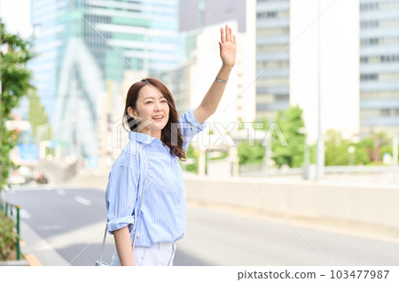 woman taking a taxi woman taking a taxi 103477987