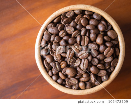 brown arabica coffee bean roast level medium taste delicate lively bright seed caffeine espresso drink food cafe beverage Chiang Rai, Thailand coffee on wooden table background top view selected focus 103478309