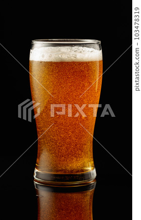 Glass of beer on a black background. Glass of beer on a black background. 103478319