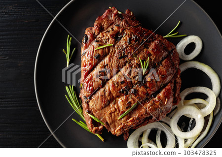 Grilled ribeye beef steak with rosemary and marinated onion. Grilled ribeye beef steak with rosemary and marinated onion. 103478325