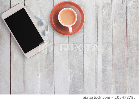 Coffee cup and smart phone on wood background. 103478783