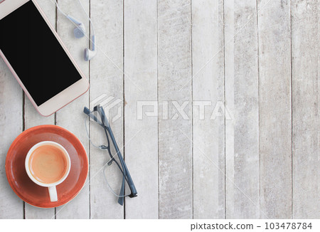 Coffee cup and smart phone on wood background. 103478784