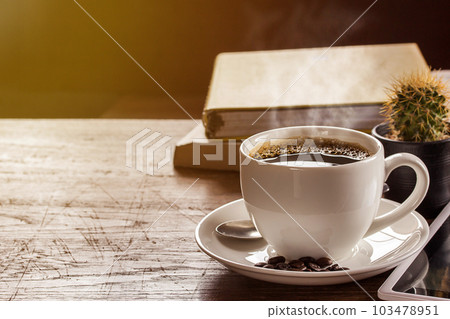 Coffee cup and note book on wooden table Coffee cup and note book on wooden table 103478951