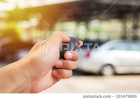 Close up hand holding car key 103479000