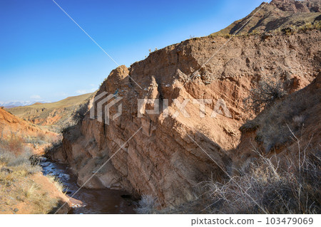 Beautiful view of cliffs from yellow red limestone. Kyrgyzstan. Beautiful view of cliffs from yellow red limestone. Kyrgyzstan. 103479069