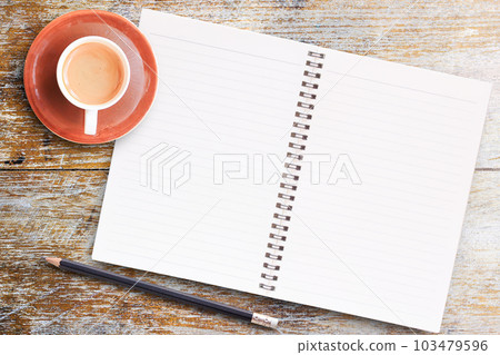 Blank paper notebook with pencil and cup of coffee on wooden table. 103479596
