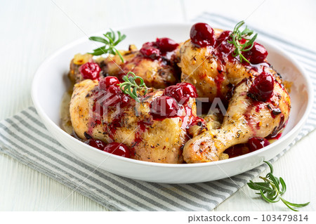 Chicken legs with cherry sauce and rosemary. 103479814