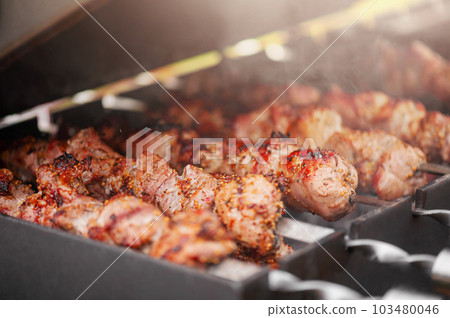 Pork is cooked in spices on the grill. Fried meat, shish kebab. Pork is cooked in spices on the grill. Fried meat, shish kebab. 103480046