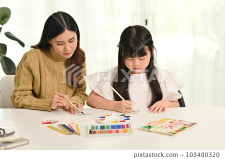 Little asian girl drawing with her mother in living room. Family home leisure concept Little asian girl drawing with her mother in living room. Family home leisure concept 103480320