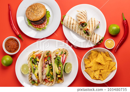 Mexican food featuring tacos, burritos, nachos, burgers Mexican food featuring tacos, burritos, nachos, burgers 103480735