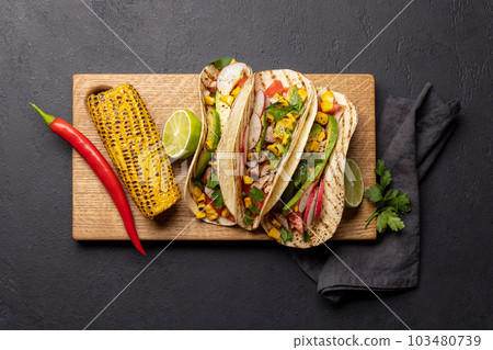 Mexican food featuring tacos and grilled vegetables 103480739