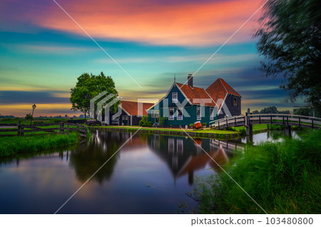 Sunset above historic farm houses in the holland village of Zaanse Schans 103480800
