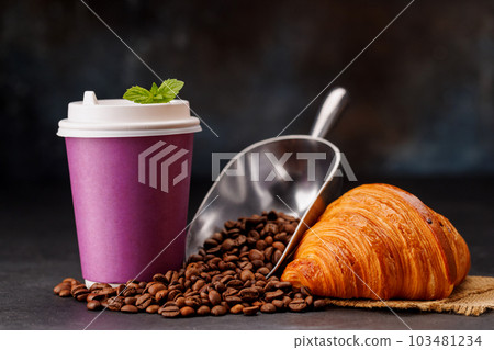 Aromatic coffee in a paper cup paired with a flaky croissant 103481234