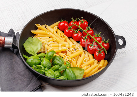 A vibrant representation of the Italian flag made with pasta, basil, and tomatoes A vibrant representation of the Italian flag made with pasta, basil, and tomatoes 103481248