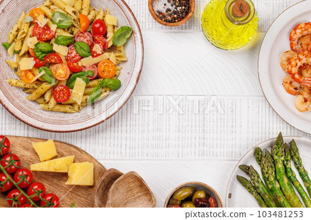 Italian pasta adorned with fresh tomatoes and aromatic basil 103481253