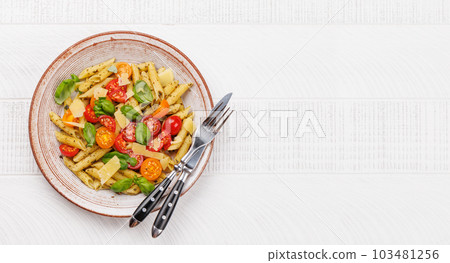 Italian pasta adorned with fresh tomatoes and aromatic basil Italian pasta adorned with fresh tomatoes and aromatic basil 103481256