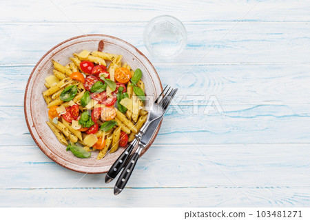 Italian pasta adorned with fresh tomatoes and aromatic basil Italian pasta adorned with fresh tomatoes and aromatic basil 103481271