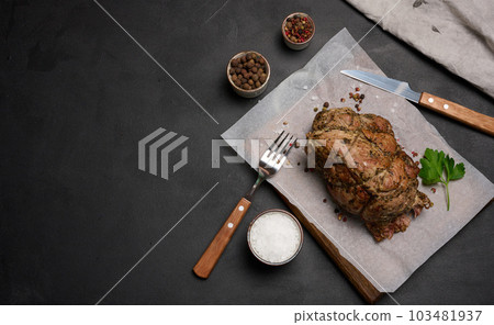 Baked pork collar with spices on a wooden board, delicious and juicy meat Baked pork collar with spices on a wooden board, delicious and juicy meat 103481937
