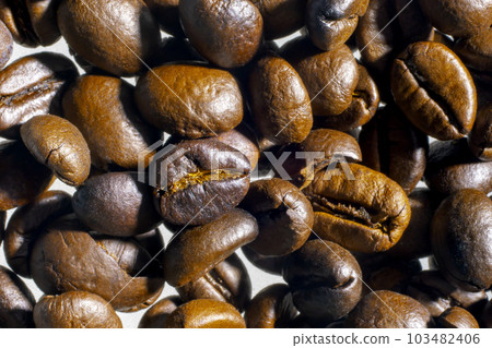 Organic coffee beans, freshly roasted, on a white background, selective focus, and soft focus. Organic coffee beans, freshly roasted, on a white background, selective focus, and soft focus. 103482406