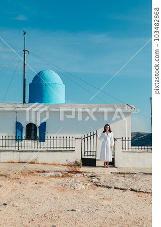 beautiful woman in white dress near old greece church beautiful woman in white dress near old greece church 103482868