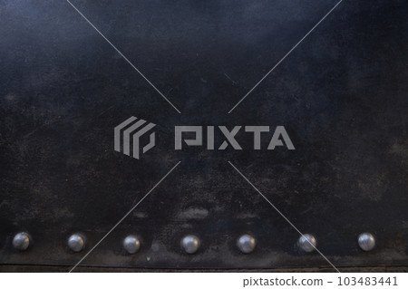 Metal rivets in a row on the scratched surface of the leather material. Overlay for your design with space to copy. High quality photo Metal rivets in a row on the scratched surface of the leather material. Overlay for your design with space to copy. High quality photo 103483441