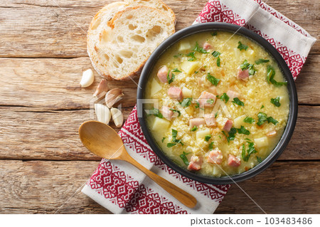 dish of Ukrainian cuisine kulish made of millet, potatoes, onions with bacon close-up in a plate. horizontal top view 103483486