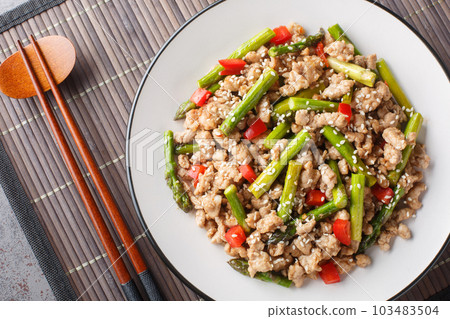 Pork Stir Fry with asparagus, garlic, chili and ginger closeup on the plate. Horizontal top view Pork Stir Fry with asparagus, garlic, chili and ginger closeup on the plate. Horizontal top view 103483504