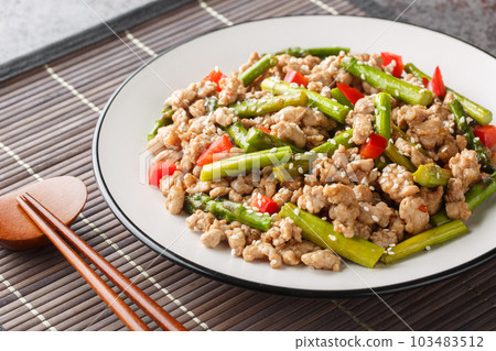 Pork Stir Fry with asparagus, garlic, chili and ginger closeup on the plate. Horizontal 103483512