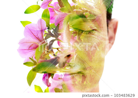 A double exposure portrait of a man and a bright pink flower 103483629