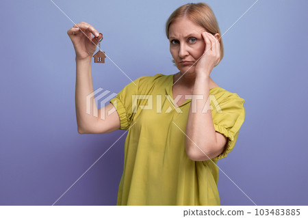 blonde middle-aged woman received the keys to a new home 103483885