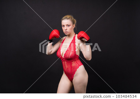 Boxer, seductive confident female boxer with gloves studio, sporty woman posing looking at camera. Boxer, seductive confident female boxer with gloves studio, sporty woman posing looking at camera. 103484534