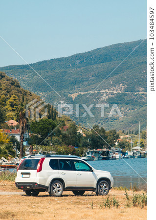 suv car at the beach of sea bay Lefkada island suv car at the beach of sea bay Lefkada island 103484597