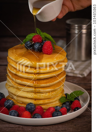 Recipe for maple syrup pancakes with raspberry and blueberry filling 103485863