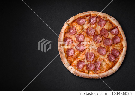 Tasty fresh pizza with salami, cheese, tomatoes, spices and salt 103486056