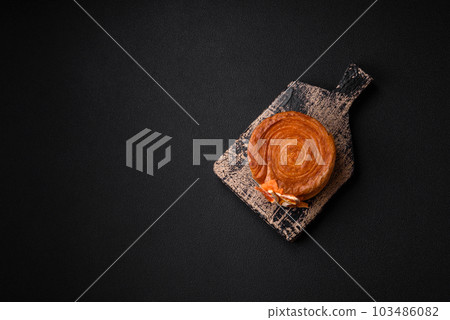 Round puff pastry croissant with citrus filling or New York roll 103486082