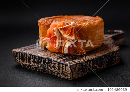 Round puff pastry croissant with citrus filling or New York roll 103486089