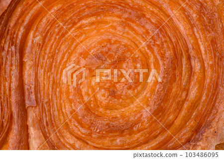 Round puff pastry croissant with citrus filling or New York roll Round puff pastry croissant with citrus filling or New York roll 103486095