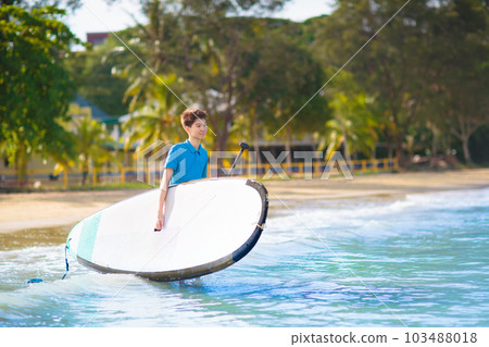 Child on stand up paddle. Water and beach sport 103488018