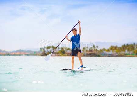 Child on stand up paddle. Water and beach sport 103488022