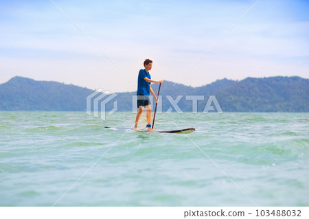 Child on stand up paddle. Water and beach sport 103488032
