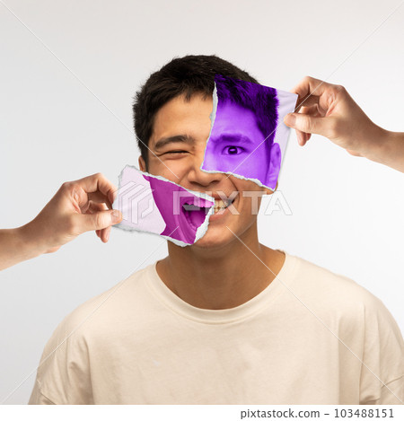 Human hands holding photo parts of young asian man's face with different emotions. Conceptual art collage. 103488151
