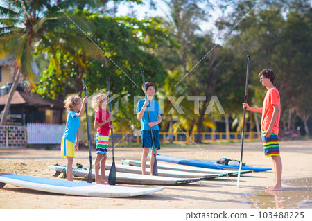 Child on stand up paddle. Water and beach sport 103488225