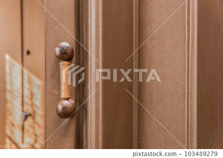 Sliding Antique Door with Wooden Handle and Shutters Retro Vintage Style Brown Background Interior 103489279