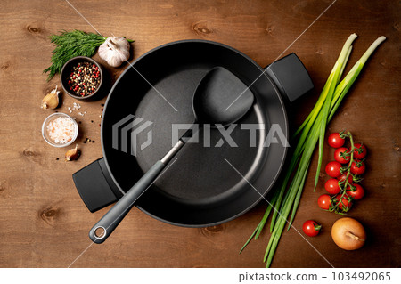 Empty pan surrounded by vegetarian Empty pan surrounded by vegetarian 103492065