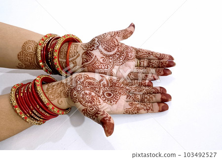 Beautiful Indian female hands with henna tattoo isolated on white background 103492527