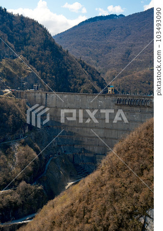 The dam of the Inguri hydroelectric power plant in the Sakartvelo mountains. A natural mountain landscape with energetic infrastructure. The dam of the Inguri hydroelectric power plant in the Sakartvelo mountains. A natural mountain landscape with energetic infrastructure. 103493090