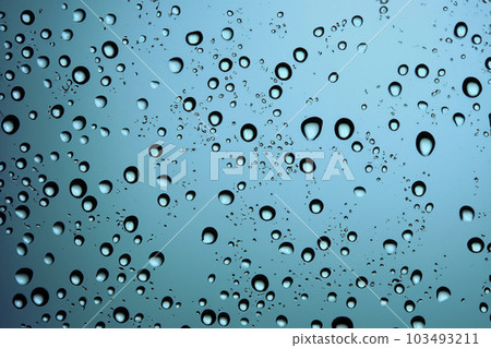 Rain. Raindrops on the window. Rainy day. Blue tone. Drops of water on the glass. Macro shooting. Texture. Concept of autumn weather, background of drops of water rain on glass transparent. Rain. Raindrops on the window. Rainy day. Blue tone. Drops of water on the glass. Macro shooting. Texture. Concept of autumn weather, background of drops of water rain on glass transparent. 103493211